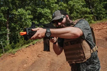 Man in airsoft gear holding airsoft rifle